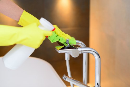 Cleaner preparing a sofa cleaning service in a Camden home