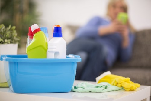 Worker applying cleaning solution with protective care